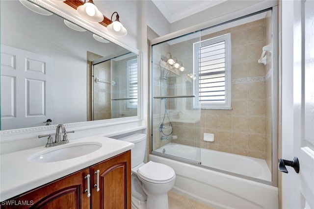 full bathroom featuring combined bath / shower with glass door, ornamental molding, vanity, tile patterned flooring, and toilet