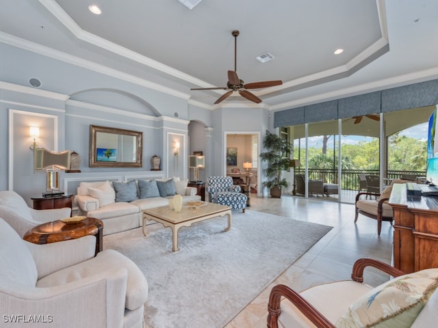 living room featuring ceiling fan, crown molding, and a tray ceiling