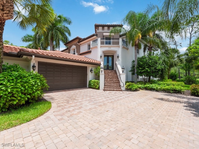 mediterranean / spanish-style house featuring a balcony and a garage