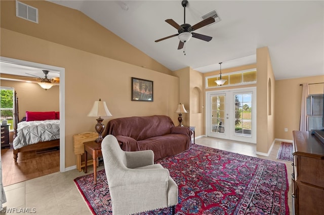 living room featuring vaulted ceiling, ceiling fan, light tile patterned floors, and plenty of natural light