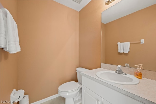 bathroom with toilet and vanity