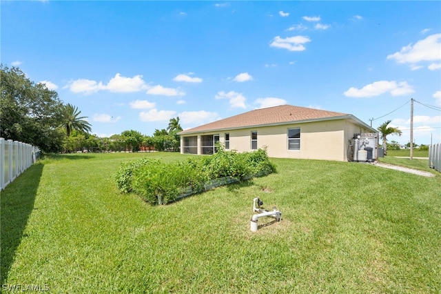 rear view of property featuring a yard