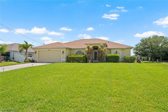 mediterranean / spanish house with a front lawn and a garage