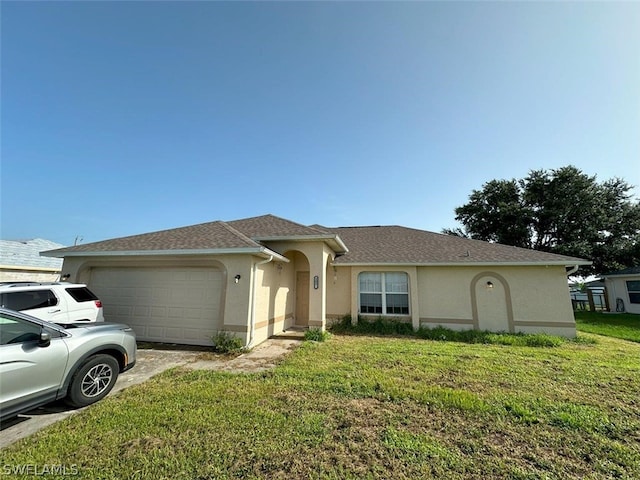 single story home featuring a garage and a front yard