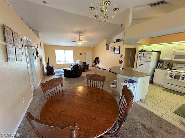 carpeted dining area featuring lofted ceiling and ceiling fan with notable chandelier