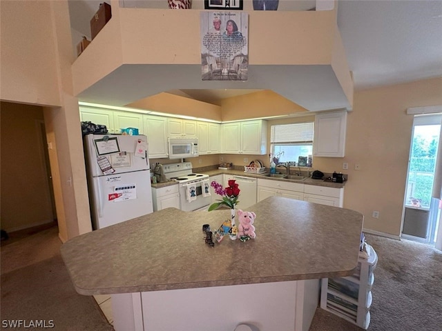 kitchen featuring sink, carpet, white appliances, and white cabinets