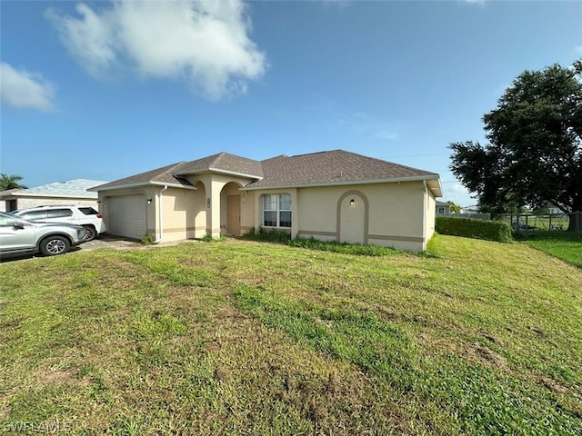 view of front of home with a garage and a front yard