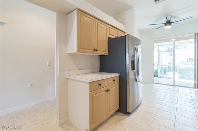 kitchen with stainless steel refrigerator with ice dispenser, light tile patterned floors, light brown cabinetry, and ceiling fan