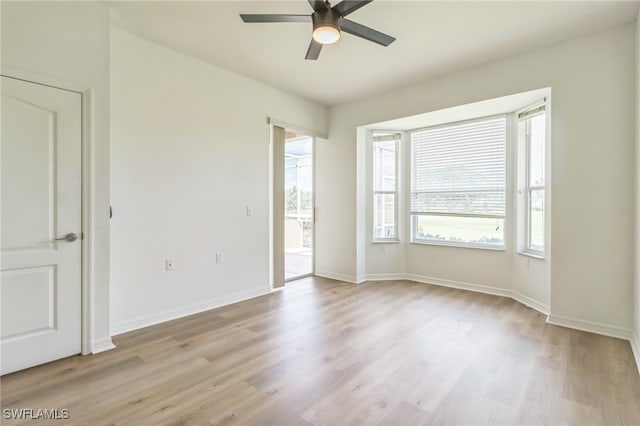 empty room featuring ceiling fan and light wood-type flooring