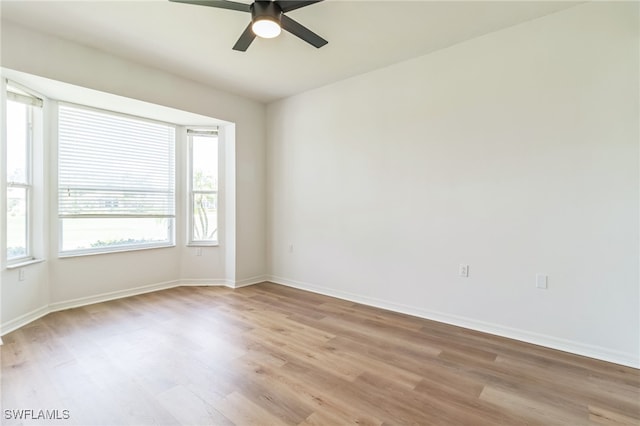 unfurnished room with ceiling fan and light wood-type flooring