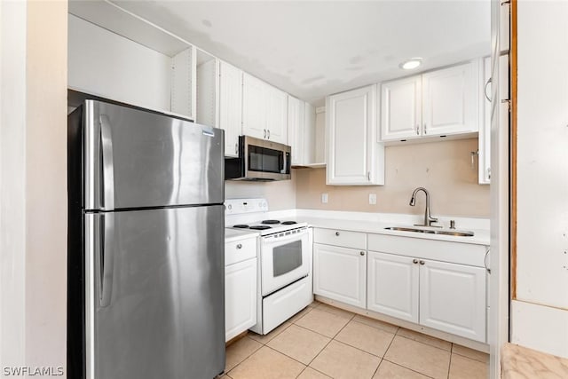 kitchen featuring white cabinets, stainless steel appliances, light countertops, a sink, and light tile patterned flooring