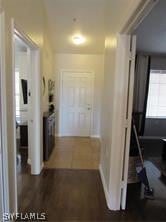 hallway with dark tile patterned flooring