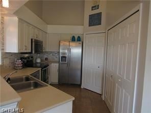 kitchen with tasteful backsplash, appliances with stainless steel finishes, and sink