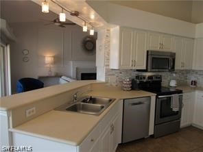 kitchen with white cabinetry, appliances with stainless steel finishes, and kitchen peninsula