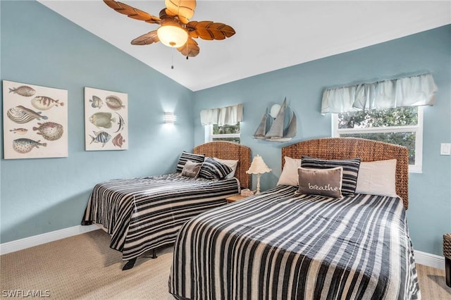bedroom featuring a ceiling fan, baseboards, and lofted ceiling