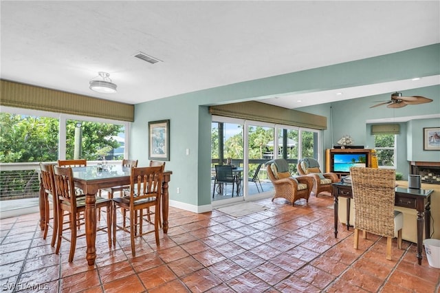 dining space with ceiling fan, baseboards, and visible vents