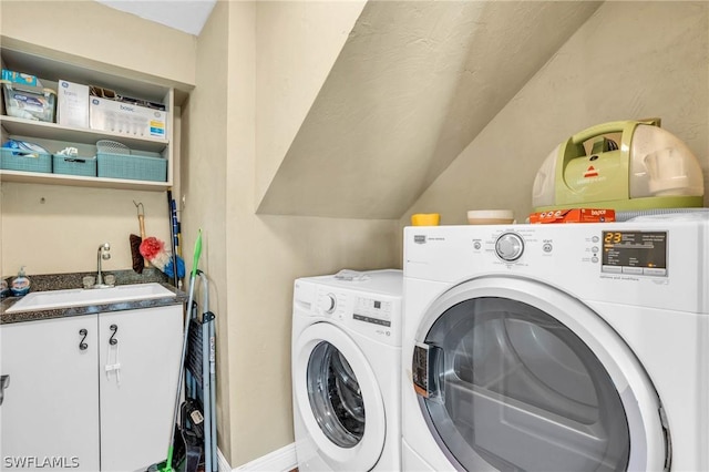 clothes washing area featuring cabinets, separate washer and dryer, and sink