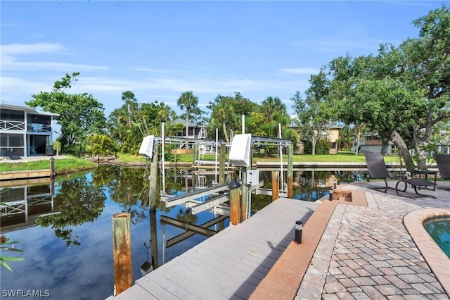 view of dock featuring boat lift and a water view