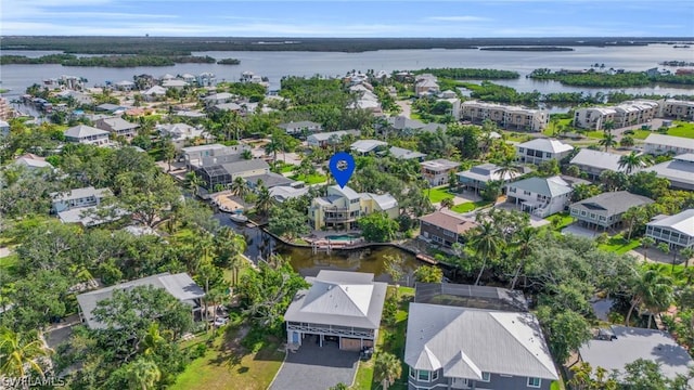 drone / aerial view with a water view and a residential view