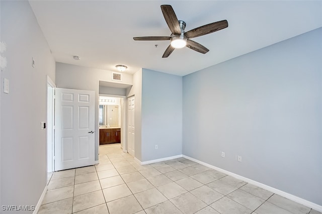 unfurnished bedroom featuring visible vents, ceiling fan, baseboards, and light tile patterned flooring