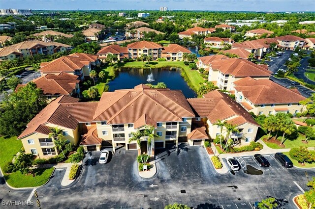 drone / aerial view with a water view and a residential view