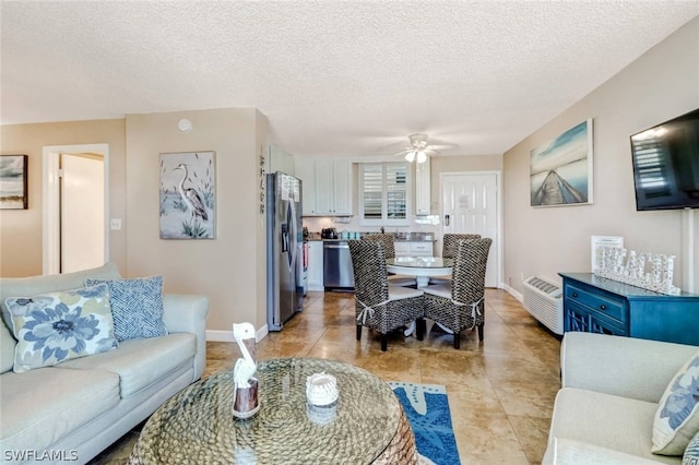 tiled living room with a textured ceiling and ceiling fan