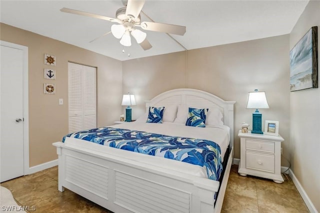 bedroom with a closet, ceiling fan, and light tile patterned flooring