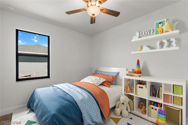 bedroom with ceiling fan and hardwood / wood-style floors