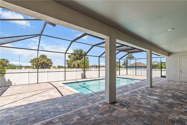 view of swimming pool featuring a lanai and a patio