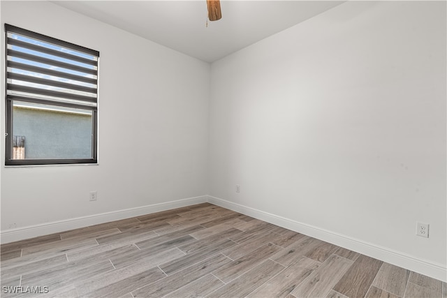 spare room with light hardwood / wood-style flooring, plenty of natural light, and ceiling fan