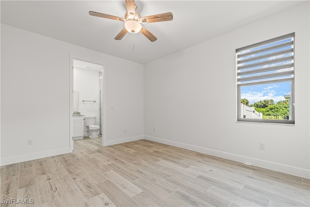 empty room featuring light wood-type flooring and ceiling fan