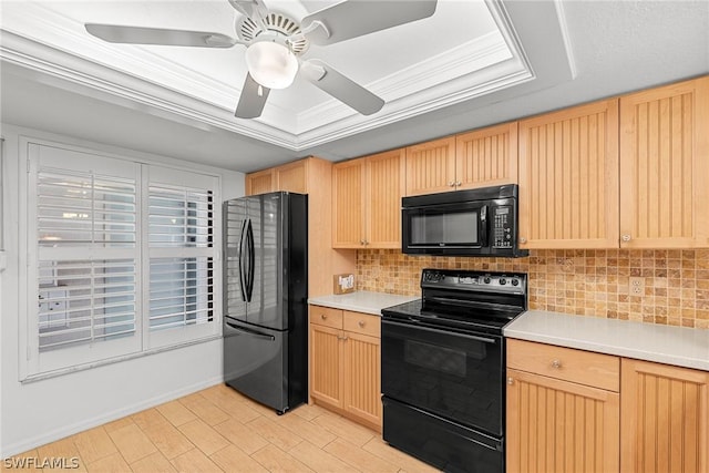 kitchen featuring tasteful backsplash, a raised ceiling, light countertops, light brown cabinets, and black appliances