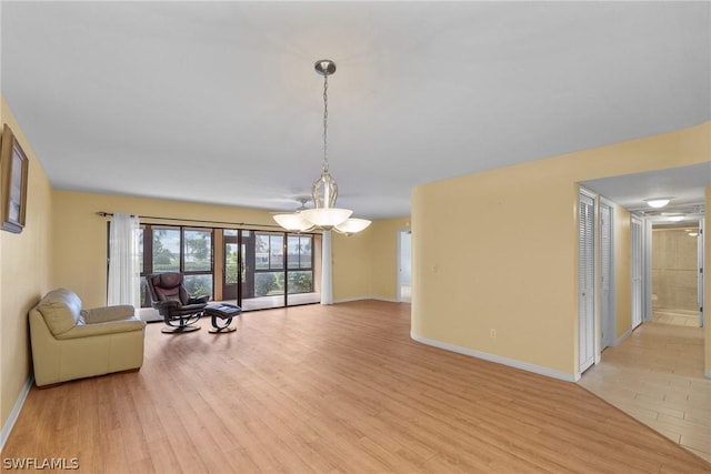 unfurnished living room with baseboards and light wood-style floors