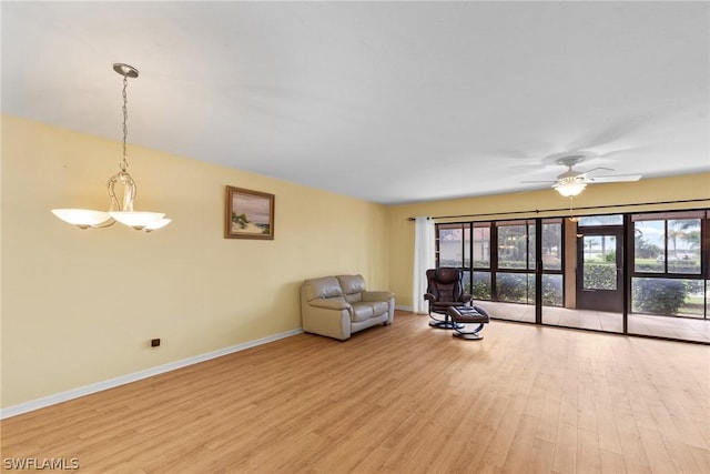 unfurnished room with light wood-type flooring, ceiling fan, and baseboards