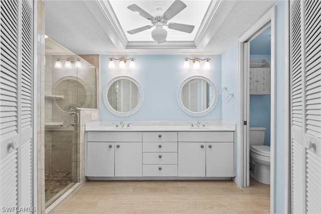 full bathroom with ornamental molding, a closet, a raised ceiling, and toilet