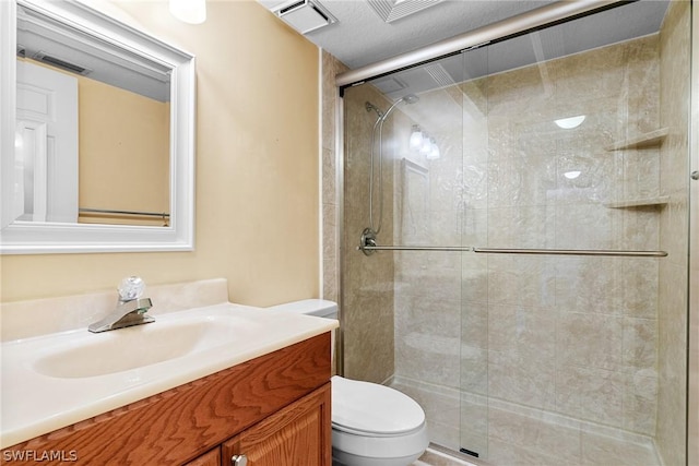 full bath with toilet, a stall shower, visible vents, and vanity