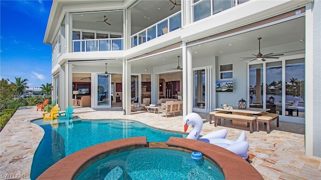 view of pool with an outdoor hangout area, a patio area, ceiling fan, and an in ground hot tub