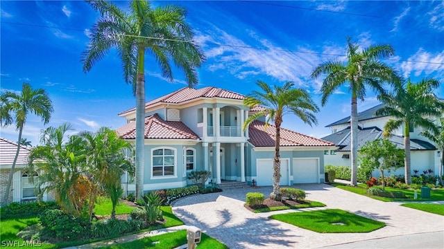 mediterranean / spanish house with a balcony and a garage