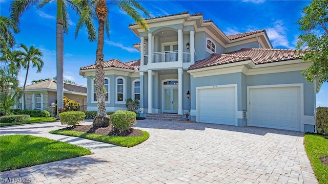 mediterranean / spanish-style house with a balcony and a garage