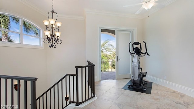 tiled entrance foyer with ornamental molding and ceiling fan with notable chandelier