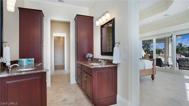 bathroom with crown molding and vanity