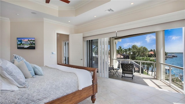 bedroom with a raised ceiling, multiple windows, crown molding, and a water view