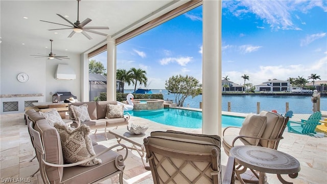 view of pool with an in ground hot tub, a water view, ceiling fan, a patio area, and an outdoor living space