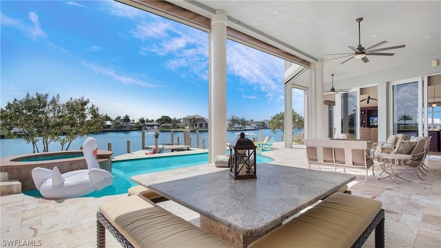 view of pool with ceiling fan, a water view, an in ground hot tub, and a patio area