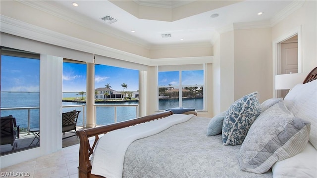 bedroom with tile patterned floors, ornamental molding, a tray ceiling, and a water view