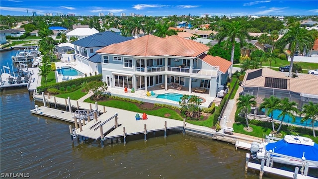 back of house featuring a patio and a water view