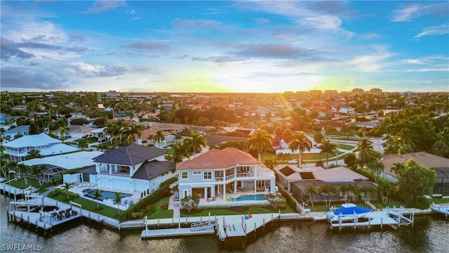 aerial view at dusk with a water view