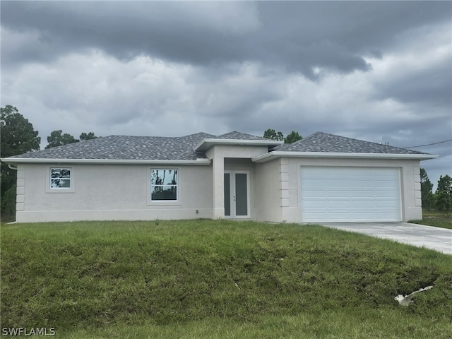 view of front of property with a garage and a front lawn