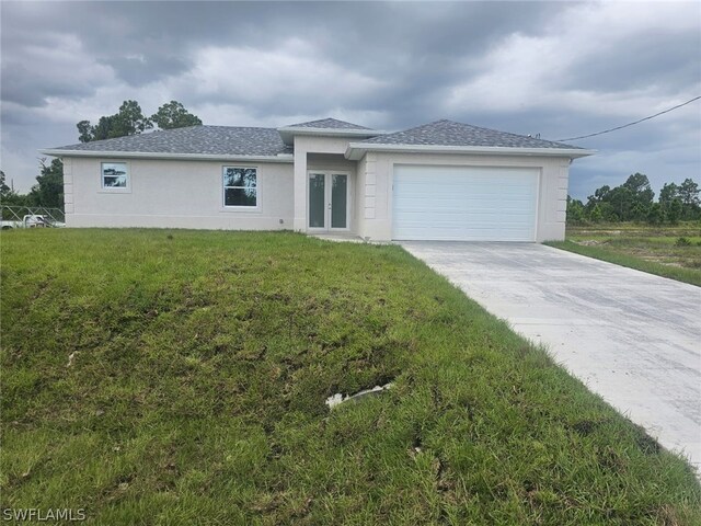 view of front of home with a garage and a front yard