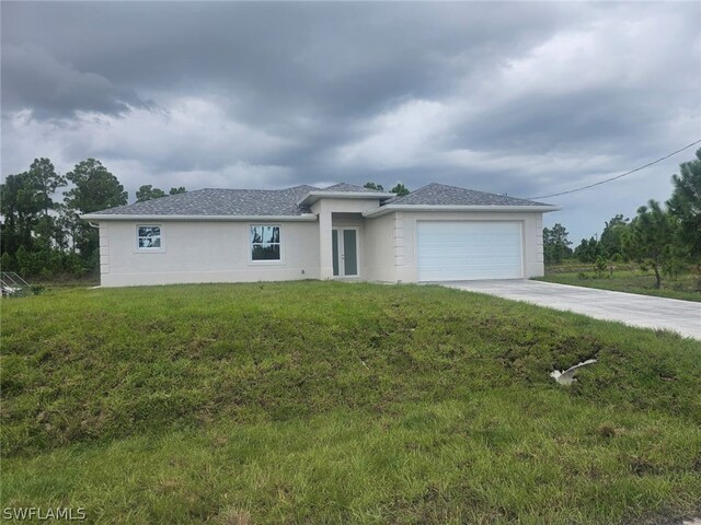 view of front of property featuring a garage and a front lawn